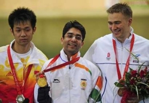 Gold medallist Abhinav Bindra of India with silver medallist Zhu Qinan of China and bronze medallist Henri Hakkinen of Finland